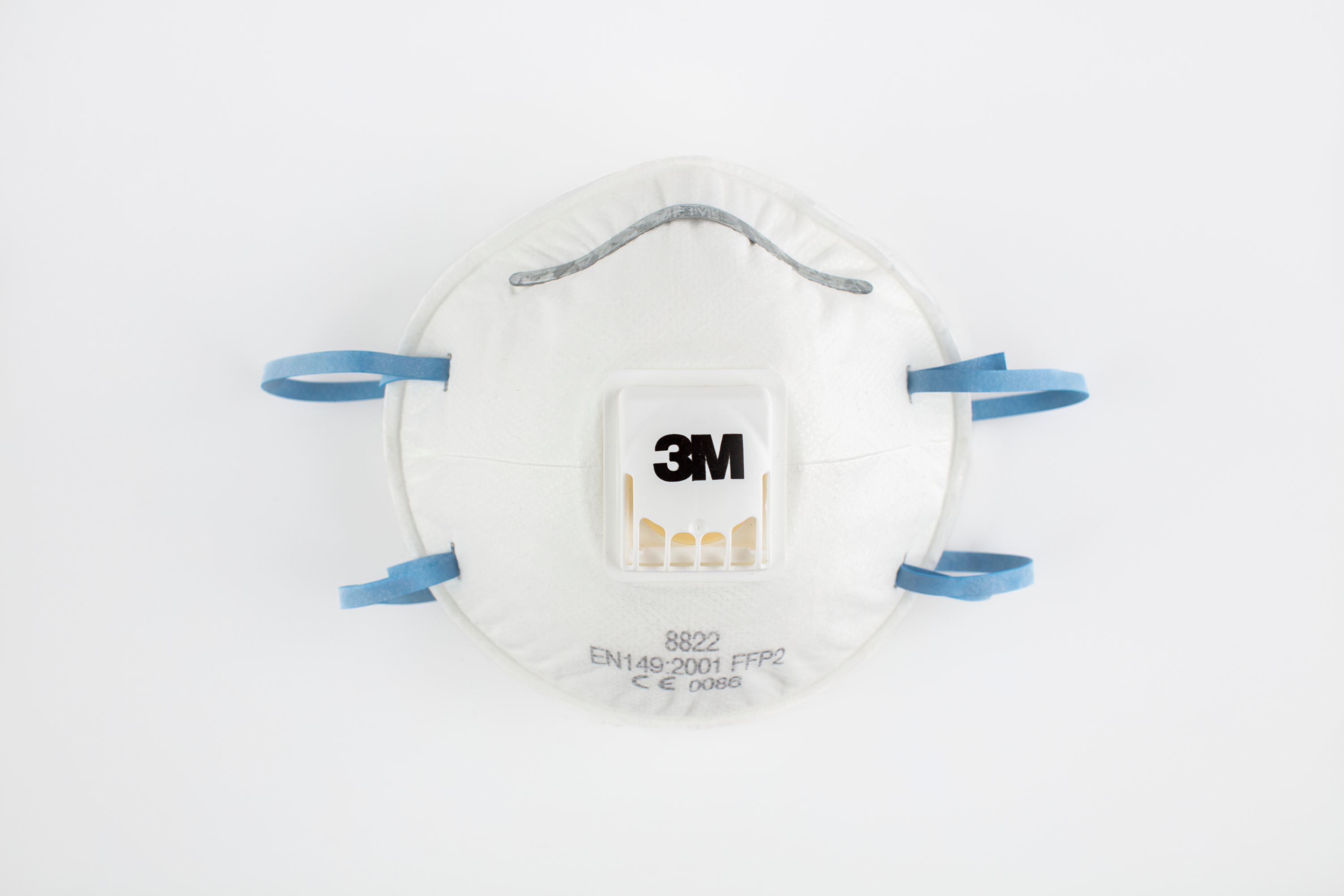 Mask made in cupped design with a metal nose strip and 3M branded valve on peak. Two blue elastic strips are stapled to the sides and serial numbers are printed in the centre of the lower half.